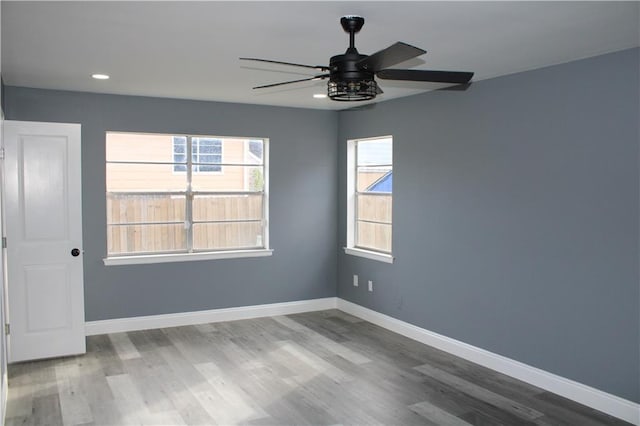 spare room with ceiling fan and hardwood / wood-style flooring