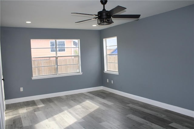 spare room with ceiling fan and dark wood-type flooring