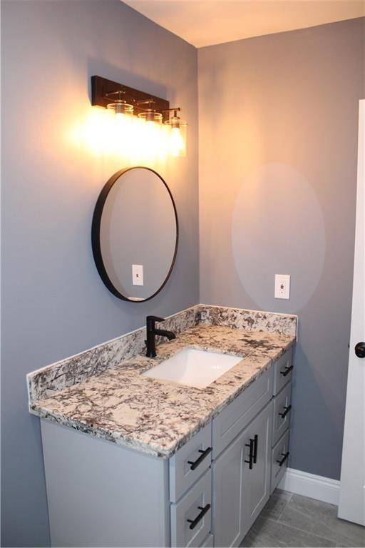 bathroom with vanity and tile patterned floors