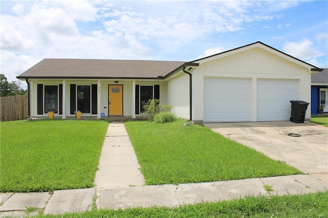 ranch-style home featuring a front lawn, covered porch, and a garage