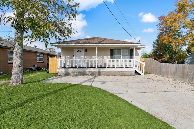 bungalow-style home with covered porch and a front yard