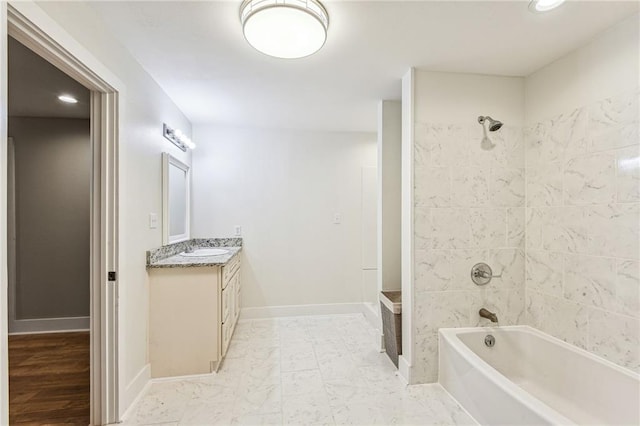 bathroom with vanity and tiled shower / bath combo