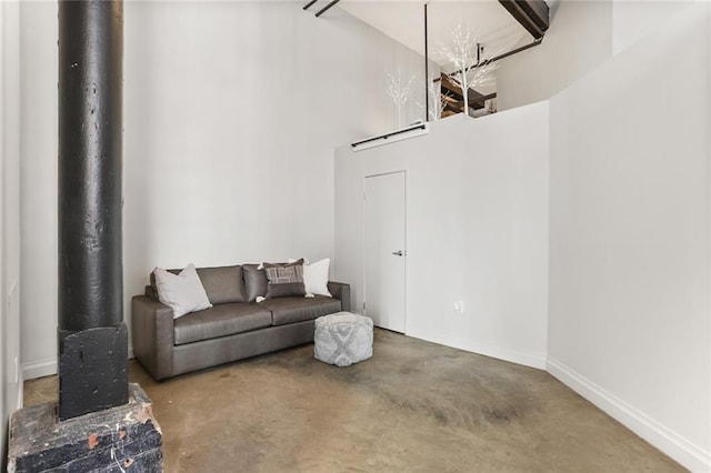 living room with concrete floors and a towering ceiling