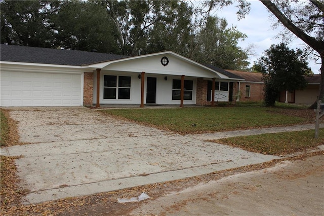 ranch-style home with covered porch, a garage, and a front yard