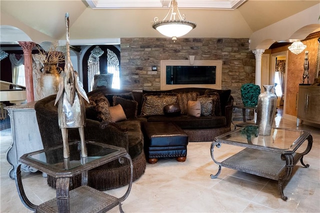 living room with a wealth of natural light, light tile flooring, vaulted ceiling, and ornate columns