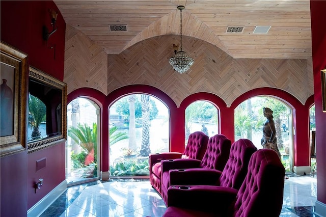 tiled living room with wood ceiling and an inviting chandelier