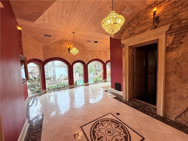 corridor with visible vents, a chandelier, wooden ceiling, tile patterned floors, and high vaulted ceiling