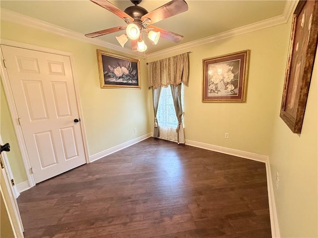 unfurnished room with baseboards, ornamental molding, ceiling fan, and dark wood-type flooring