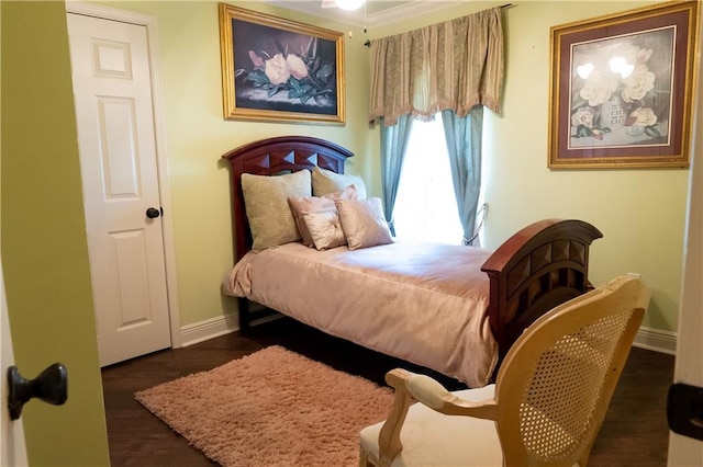 bedroom with dark hardwood / wood-style floors