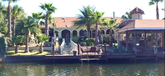 back of property featuring a water view