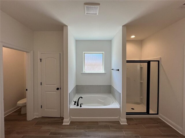 bathroom featuring independent shower and bath and toilet