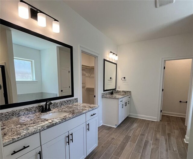 bathroom featuring vanity and hardwood / wood-style floors