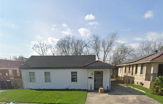 ranch-style house with a carport and a front yard