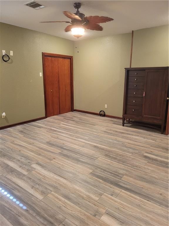 spare room featuring ceiling fan and light hardwood / wood-style flooring