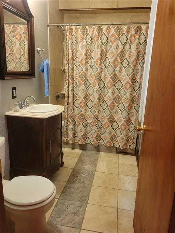 bathroom with vanity, toilet, and tile floors