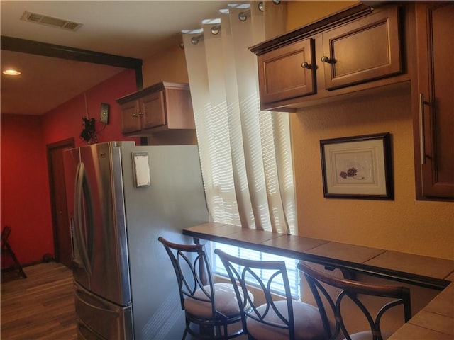 kitchen with stainless steel refrigerator and dark hardwood / wood-style flooring