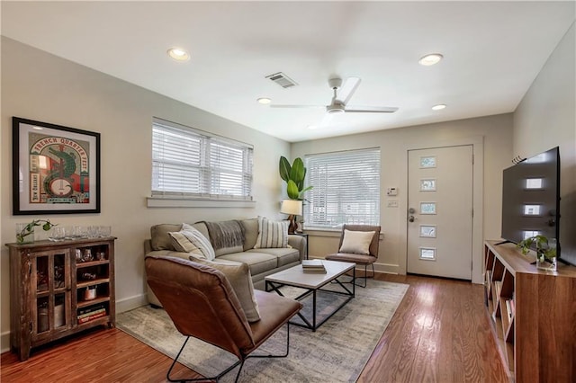 living room with hardwood / wood-style floors and ceiling fan