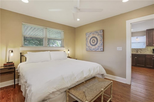 bedroom featuring dark hardwood / wood-style floors, ceiling fan, and ensuite bathroom