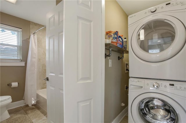 laundry room featuring hookup for a washing machine, stacked washing maching and dryer, and light tile flooring