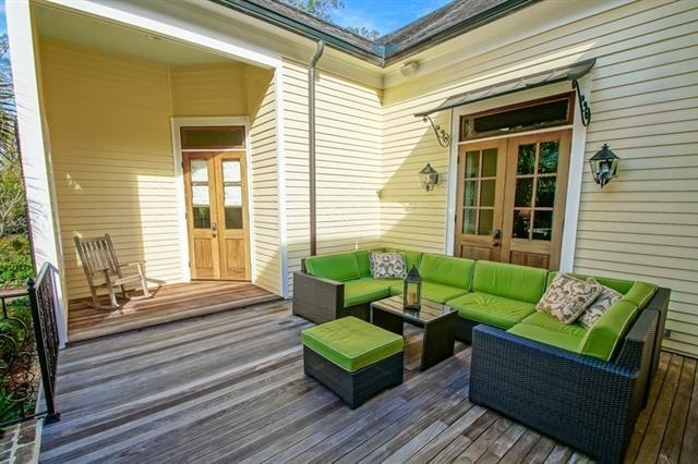 wooden terrace featuring french doors and an outdoor living space