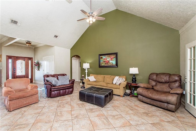 tiled living room featuring high vaulted ceiling, a textured ceiling, a healthy amount of sunlight, and ceiling fan