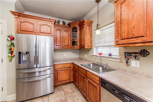 kitchen featuring stainless steel appliances, light tile floors, decorative light fixtures, sink, and crown molding