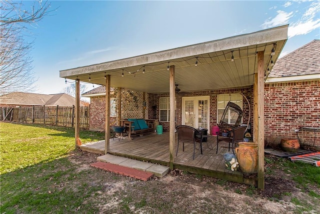 wooden deck with french doors and a yard