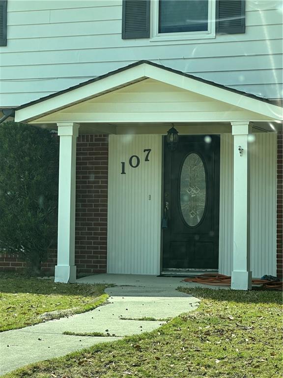 doorway to property with a yard