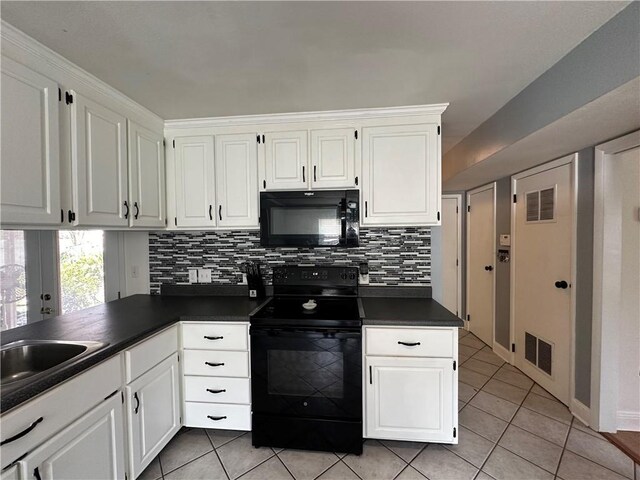 kitchen with black appliances, white cabinets, and light tile flooring