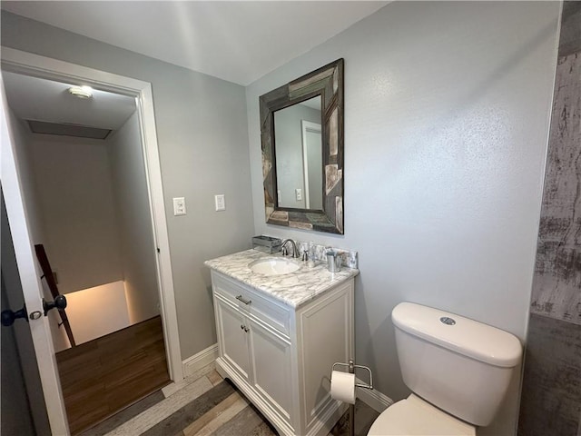 bathroom featuring hardwood / wood-style floors, toilet, and vanity