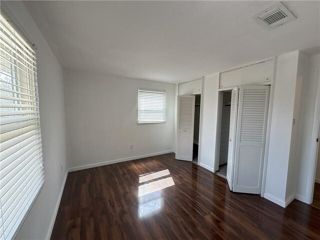 unfurnished bedroom featuring dark wood-type flooring