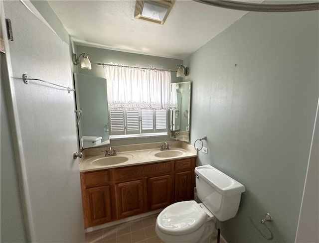 bathroom with oversized vanity, double sink, toilet, and tile floors