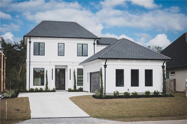 view of front facade featuring a garage and a front lawn