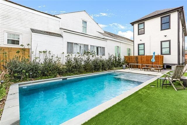 view of swimming pool with a patio area and a yard