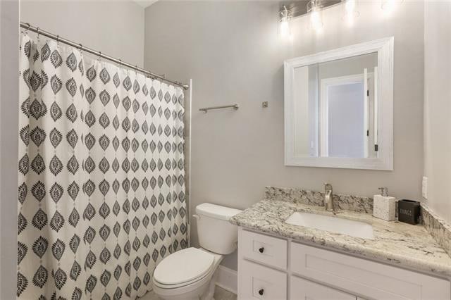 bathroom featuring vanity and toilet