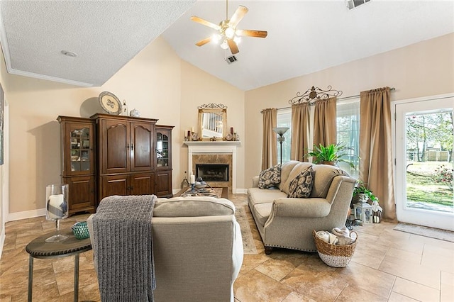 tiled living room featuring a textured ceiling, a tiled fireplace, ceiling fan, and high vaulted ceiling