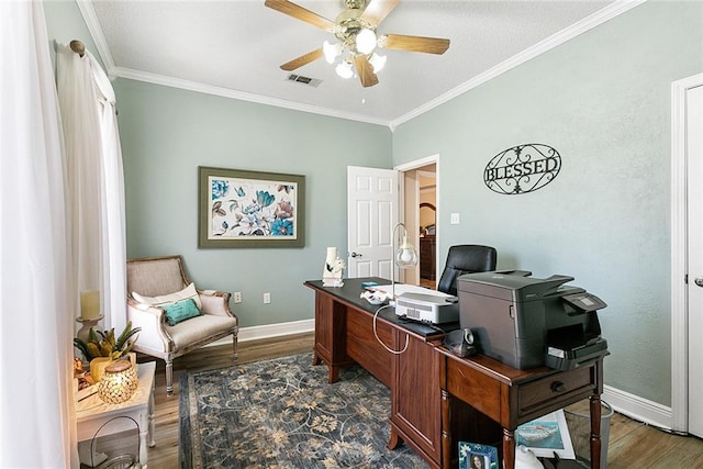 home office featuring dark wood-type flooring, ceiling fan, and ornamental molding