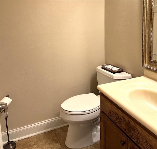 bathroom with tile patterned flooring, toilet, and vanity