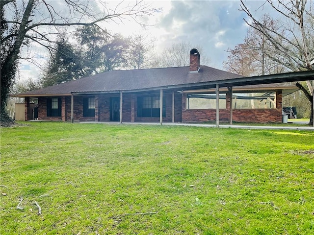 rear view of property featuring a yard