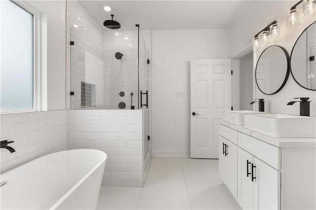 bathroom with independent shower and bath, vanity, and tile flooring