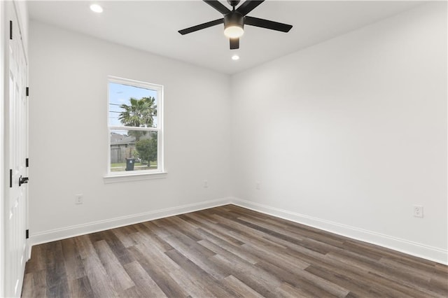 empty room with dark hardwood / wood-style floors and ceiling fan