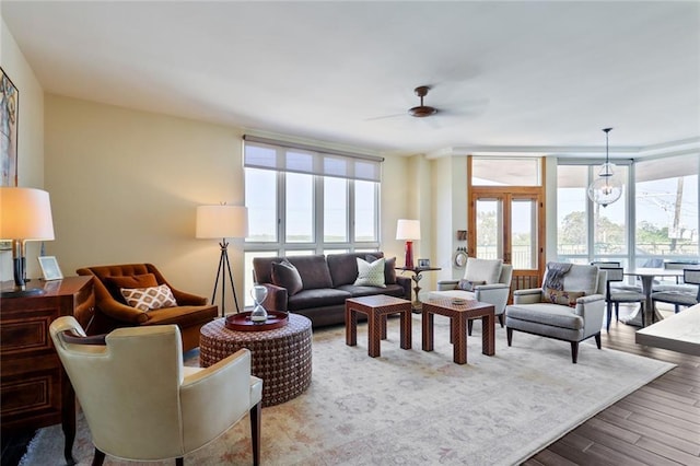 living room featuring a wall of windows, french doors, hardwood / wood-style floors, and ceiling fan