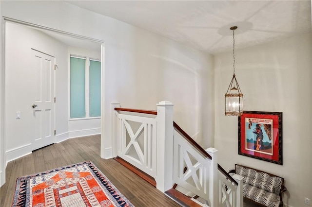 hall featuring hardwood / wood-style floors and a notable chandelier