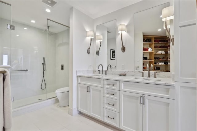 bathroom with toilet, tile patterned flooring, an enclosed shower, and vanity