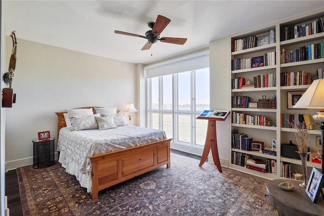 bedroom featuring ceiling fan and dark wood-type flooring