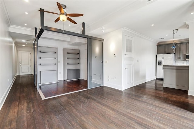 unfurnished living room with ceiling fan, ornamental molding, and dark hardwood / wood-style floors