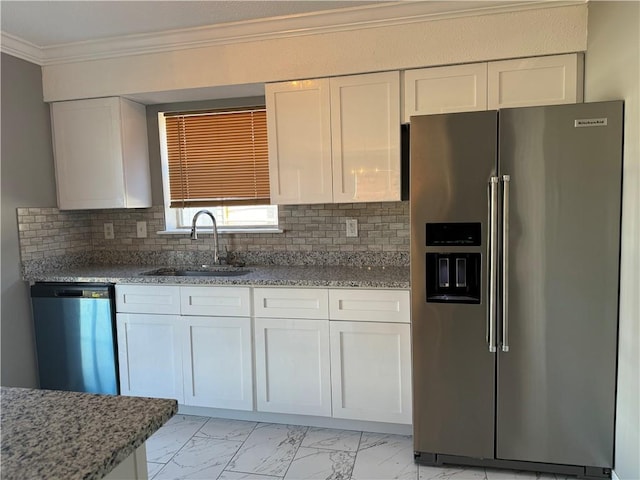 kitchen with tasteful backsplash, light stone counters, stainless steel appliances, sink, and white cabinets