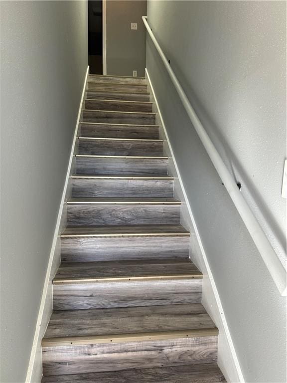 stairs with dark hardwood / wood-style floors