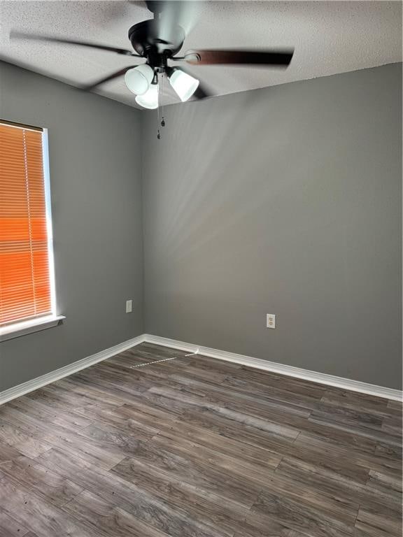 unfurnished room featuring ceiling fan, a textured ceiling, and dark hardwood / wood-style floors