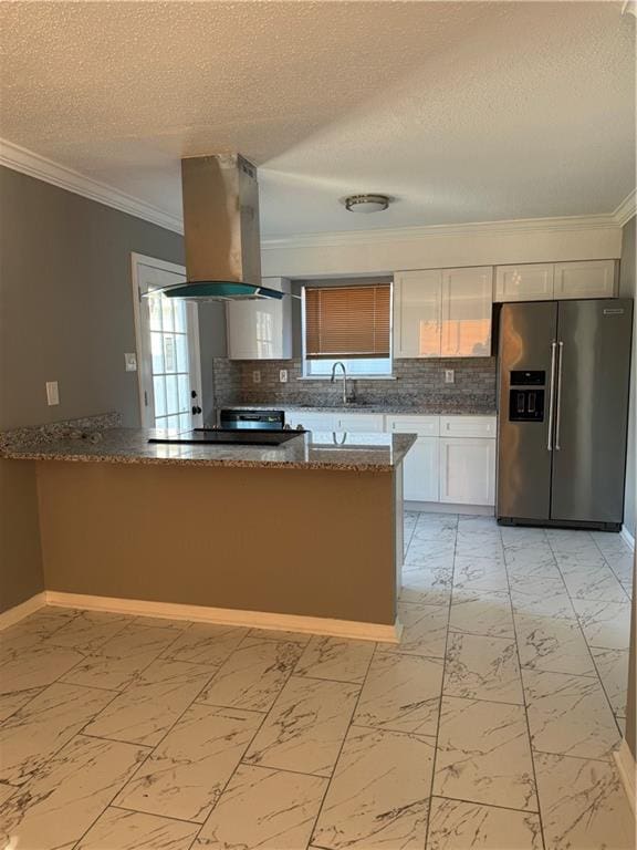 kitchen with kitchen peninsula, island exhaust hood, dark stone countertops, stainless steel refrigerator with ice dispenser, and white cabinetry